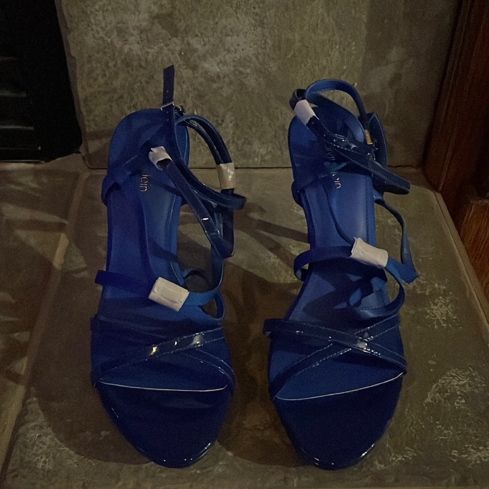 Calvin Klein Blue patent leather sandal.